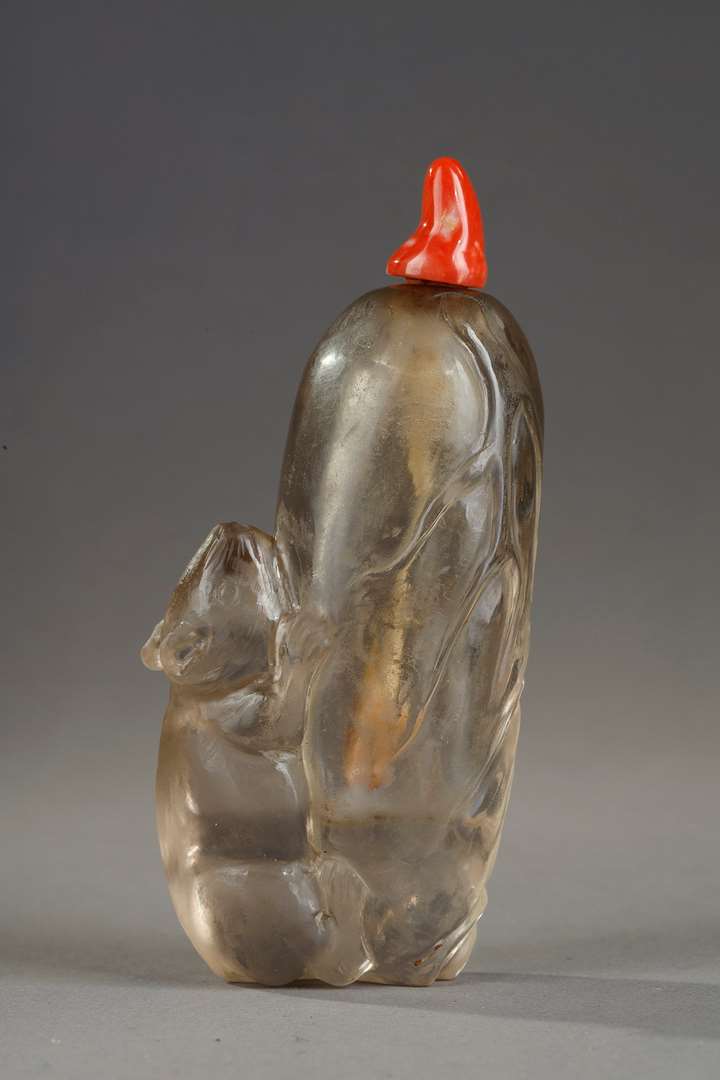 Rock crystal snuff bottle representing a loir on a legume